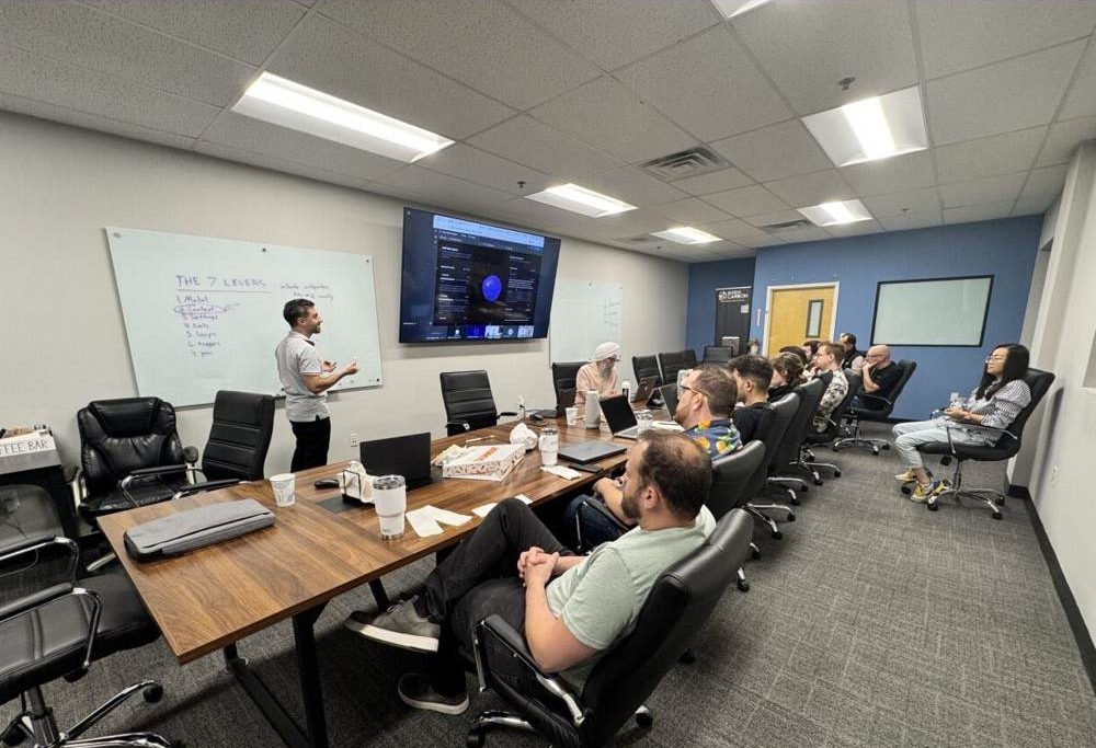 Instructor at the whiteboard with participants around a conference table